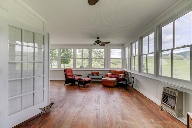 sunroom / solarium with ceiling fan and heating unit