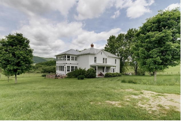 back of property featuring a lawn