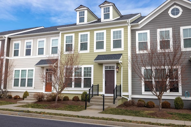 multi unit property featuring roof with shingles