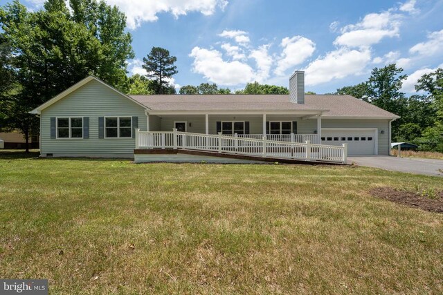 ranch-style house featuring a garage, covered porch, and a front lawn