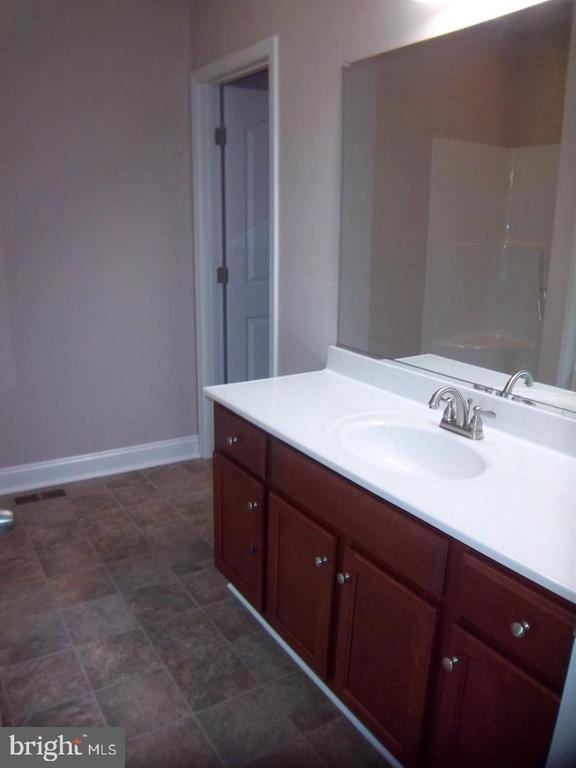 bathroom featuring vanity and walk in shower