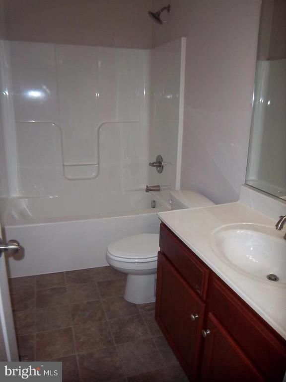 full bathroom with vanity, bathtub / shower combination, and toilet