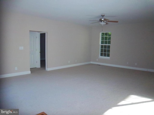 spare room with ceiling fan and carpet flooring