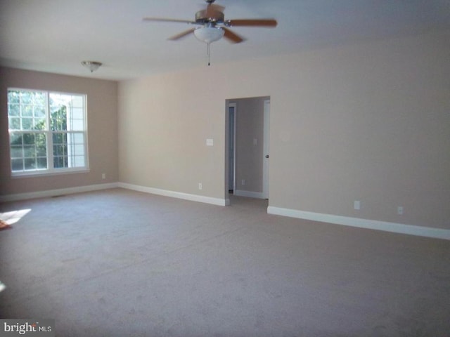 carpeted spare room with ceiling fan