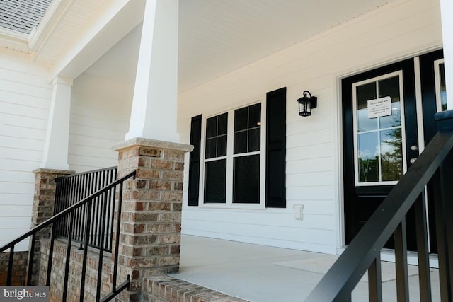 view of exterior entry featuring a porch