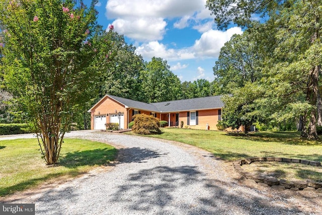 ranch-style house featuring a garage and a front lawn