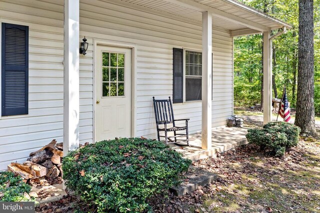 view of exterior entry featuring a porch