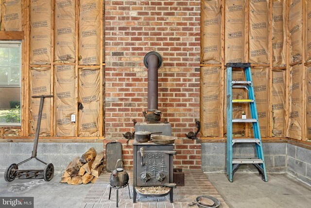 room details with concrete flooring and a wood stove