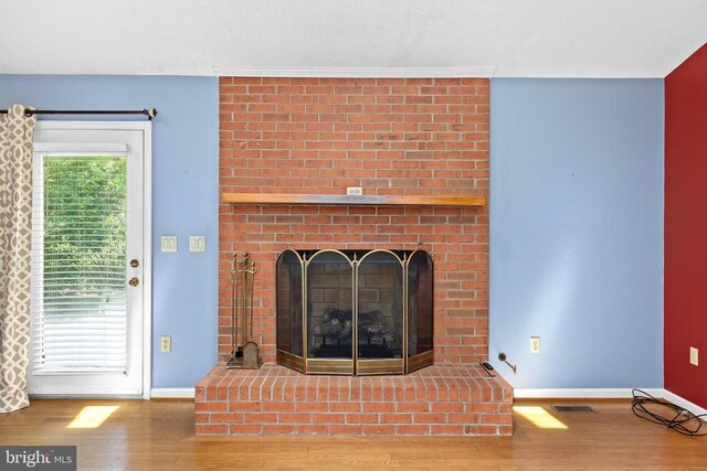 unfurnished living room featuring hardwood / wood-style flooring and a fireplace