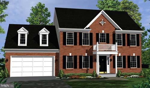 colonial home featuring a garage and a balcony