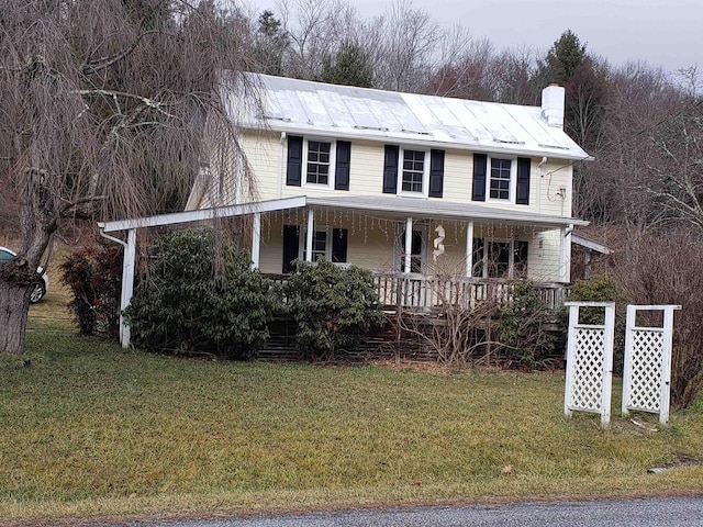 view of front of property with covered porch and a front lawn