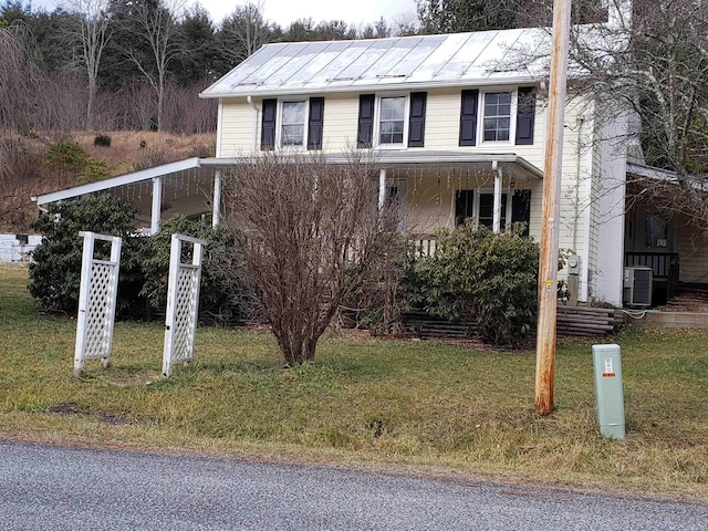 view of front of house featuring central AC and a front yard