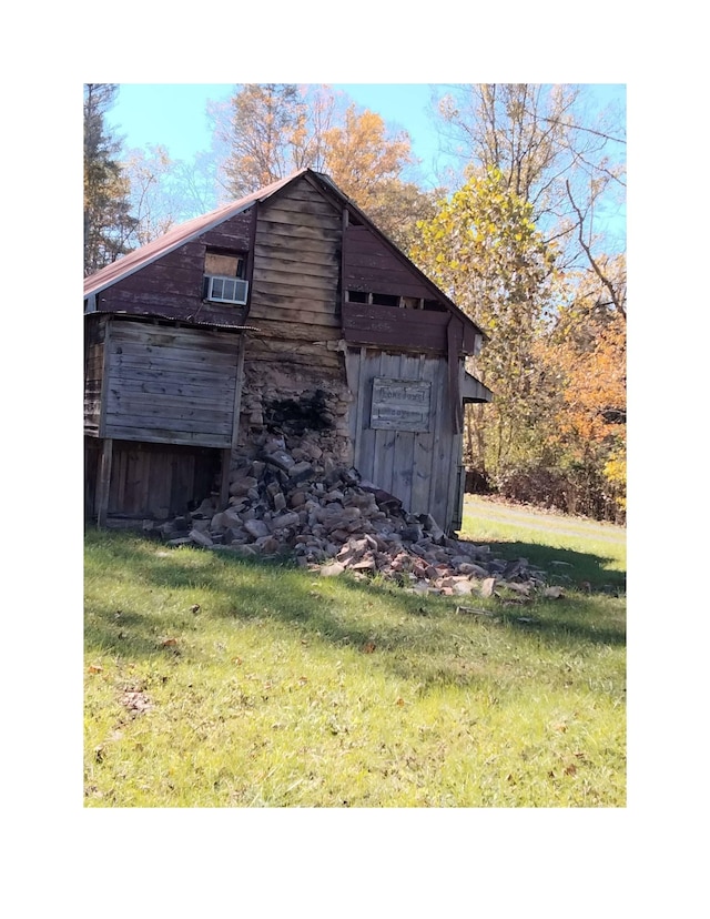 view of outbuilding with a yard