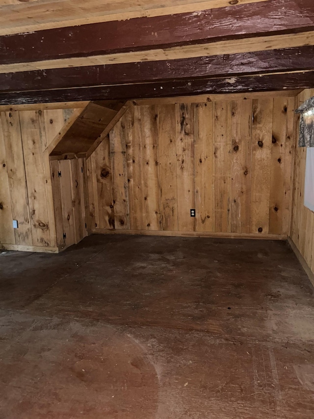 basement with dark wood-type flooring and wood walls