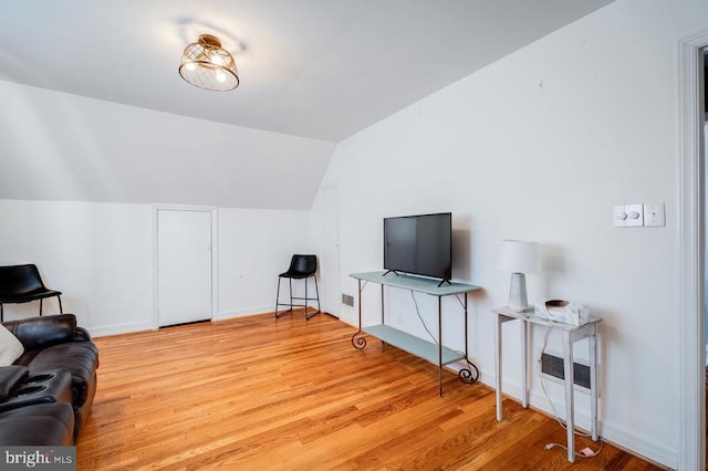 sitting room with lofted ceiling and light wood-type flooring