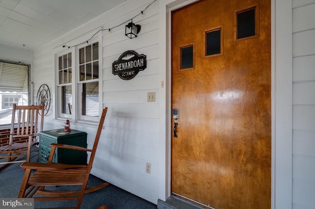 view of exterior entry with covered porch