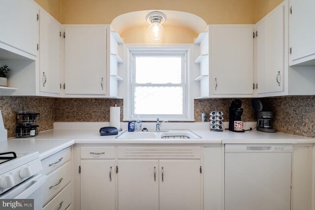 kitchen featuring a sink, white cabinetry, white dishwasher, and open shelves