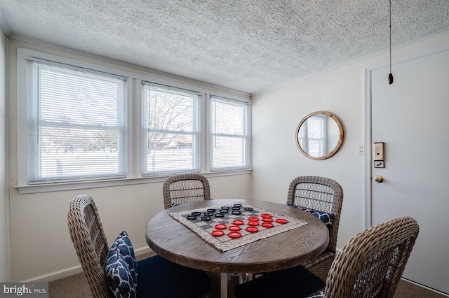 dining area with baseboards and a textured ceiling