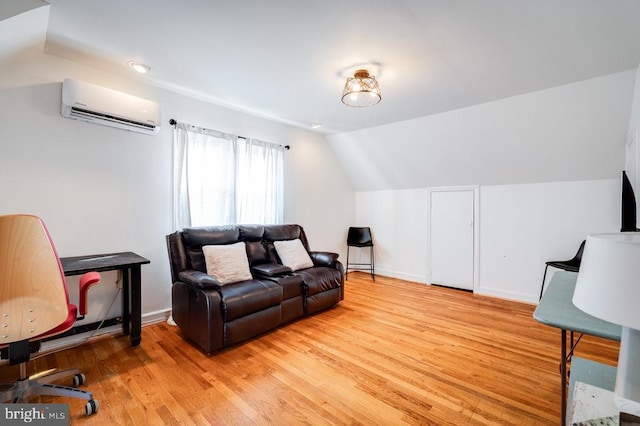 living room featuring light wood-style flooring, a wall mounted AC, and vaulted ceiling