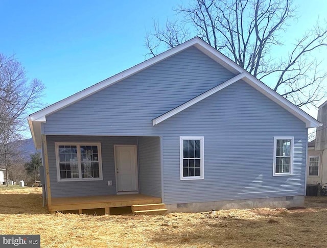 rear view of property with crawl space and covered porch