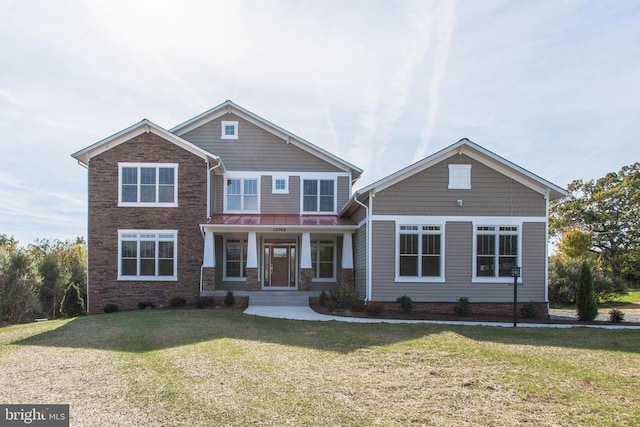 craftsman-style home featuring a porch and a front lawn