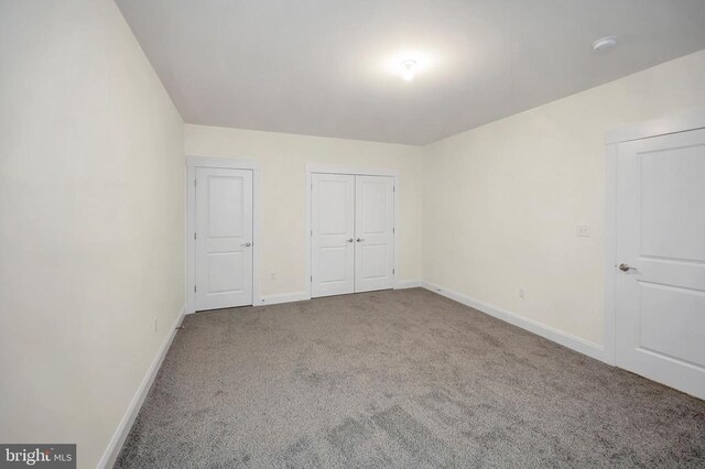 unfurnished bedroom with carpet floors and a closet