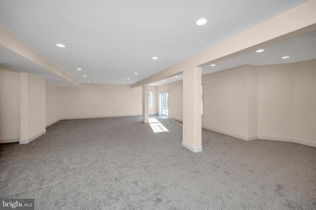 basement featuring light carpet