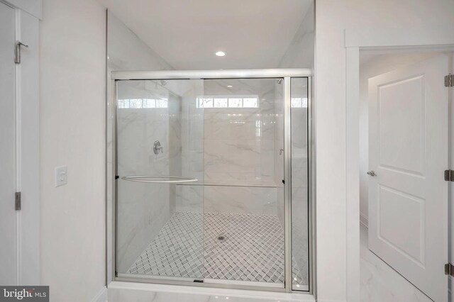 bathroom with a shower with shower door