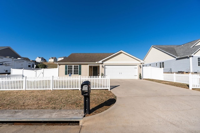 ranch-style house featuring a fenced front yard, an attached garage, and concrete driveway