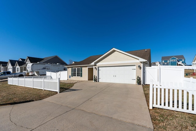 view of front of home featuring concrete driveway, an attached garage, fence, and a residential view