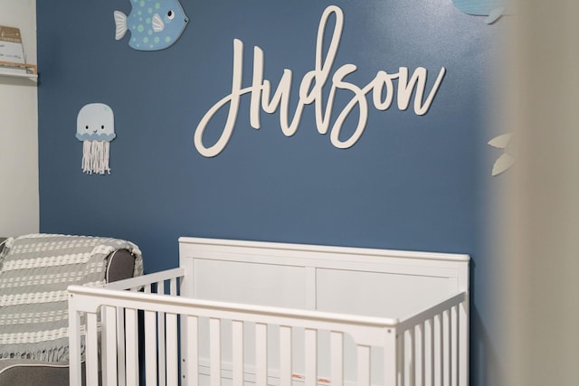 bedroom featuring a nursery area