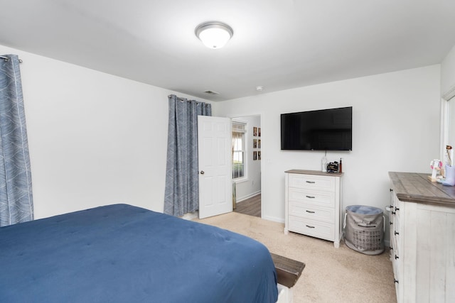 bedroom featuring visible vents and light carpet