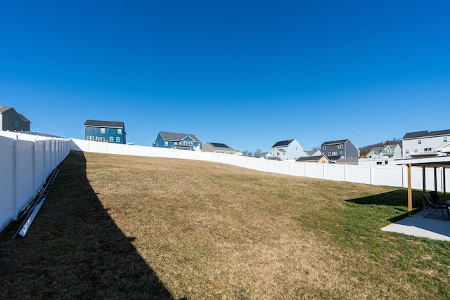 view of yard with a residential view and a fenced backyard