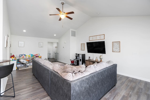 living area featuring visible vents, dark wood-type flooring, high vaulted ceiling, baseboards, and ceiling fan