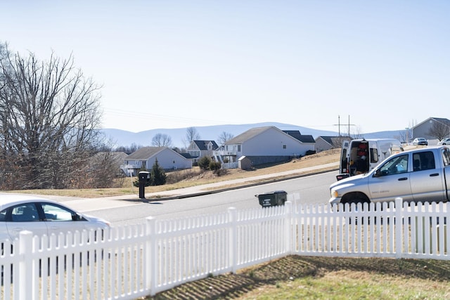 view of yard with a fenced front yard and a mountain view