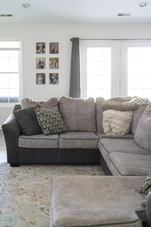 living room with visible vents, recessed lighting, and wood finished floors