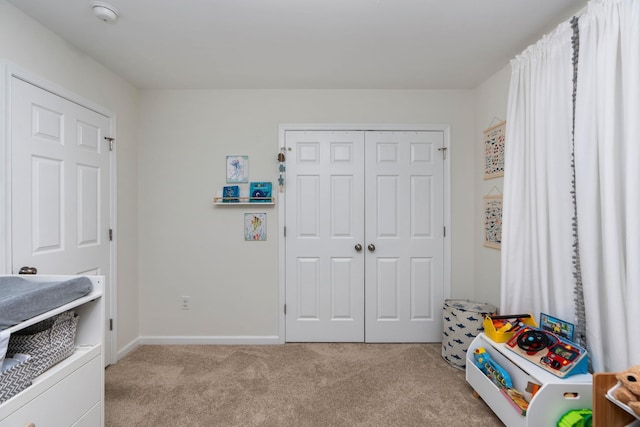 recreation room featuring baseboards and carpet floors