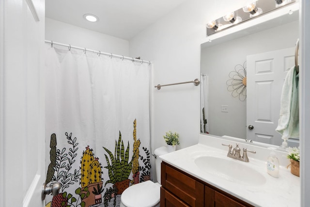 bathroom featuring vanity, curtained shower, and toilet