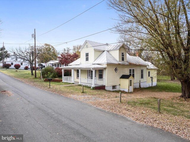 view of side of property featuring a porch