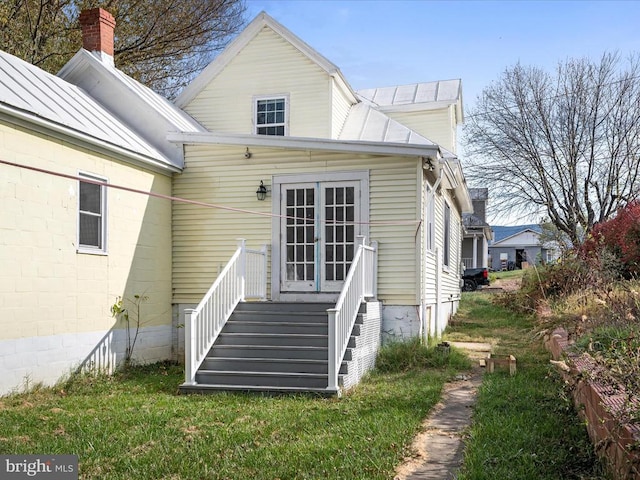 rear view of property featuring a yard