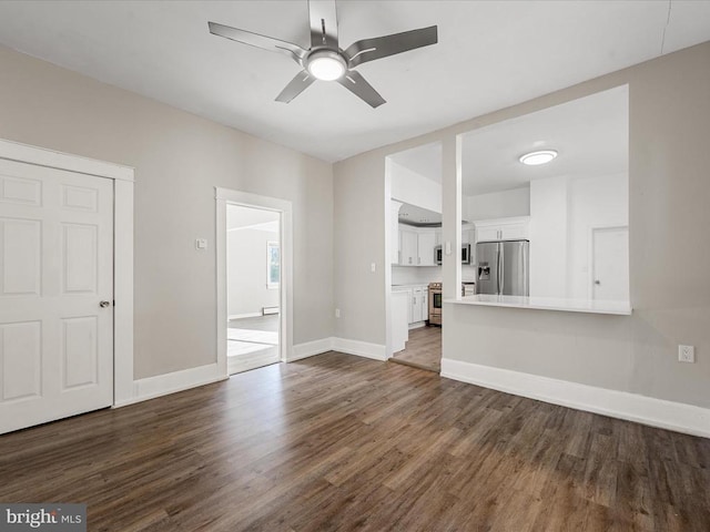 unfurnished living room with dark wood-type flooring and ceiling fan