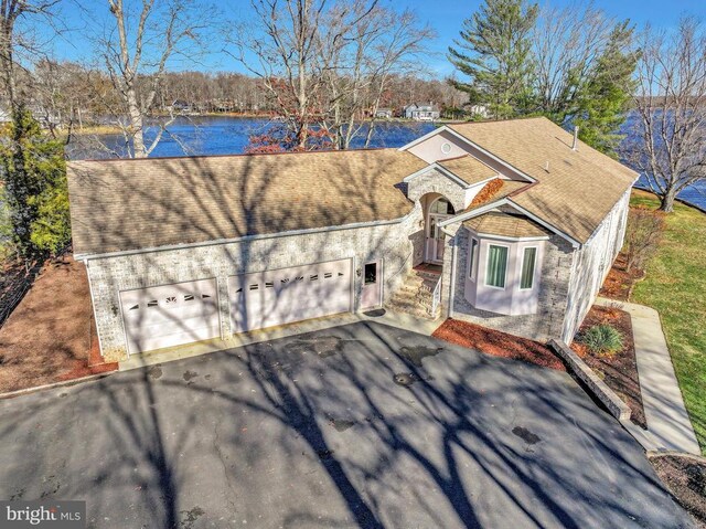 view of front of home featuring a water view and a garage