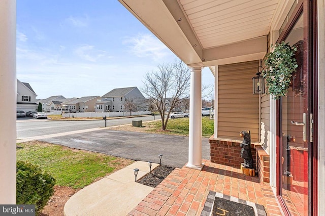 view of patio / terrace with a residential view and a porch