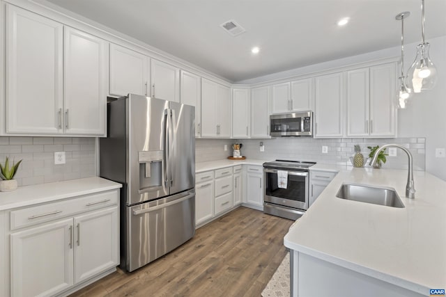 kitchen featuring light countertops, appliances with stainless steel finishes, and white cabinetry