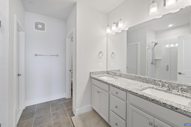 bathroom with a stall shower, tile patterned flooring, a sink, and toilet