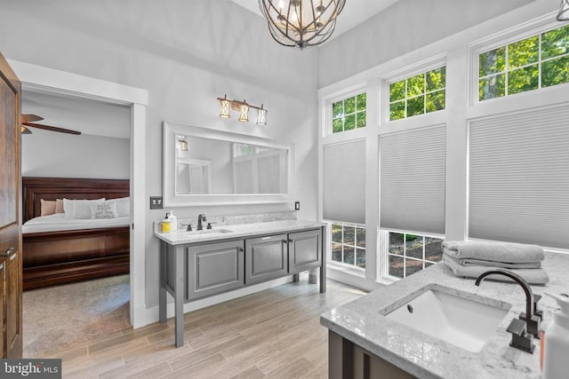 bathroom featuring vanity, hardwood / wood-style floors, and an inviting chandelier