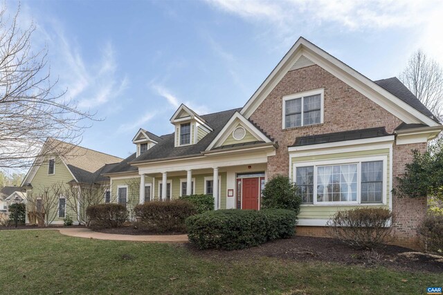 view of front of home with brick siding and a front lawn