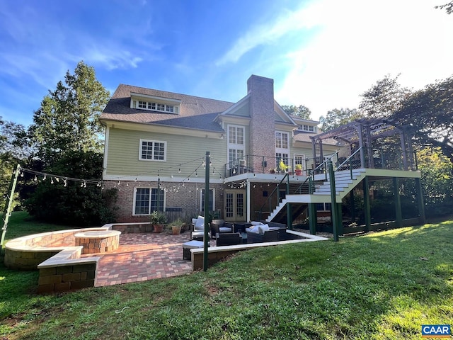 back of property featuring a pergola, stairs, french doors, a patio area, and a lawn