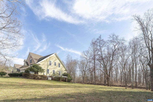 view of side of property featuring a yard