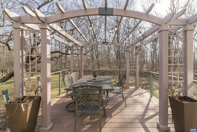 wooden terrace with a pergola and outdoor dining area